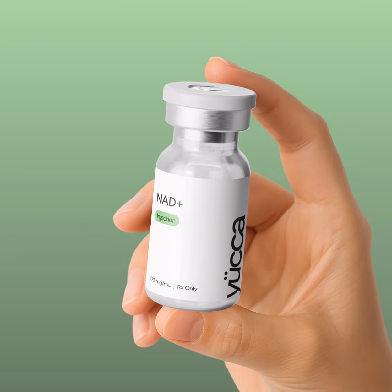 Hand holding NAD+ longevity injection vial 100mg/mL — Yucca Health